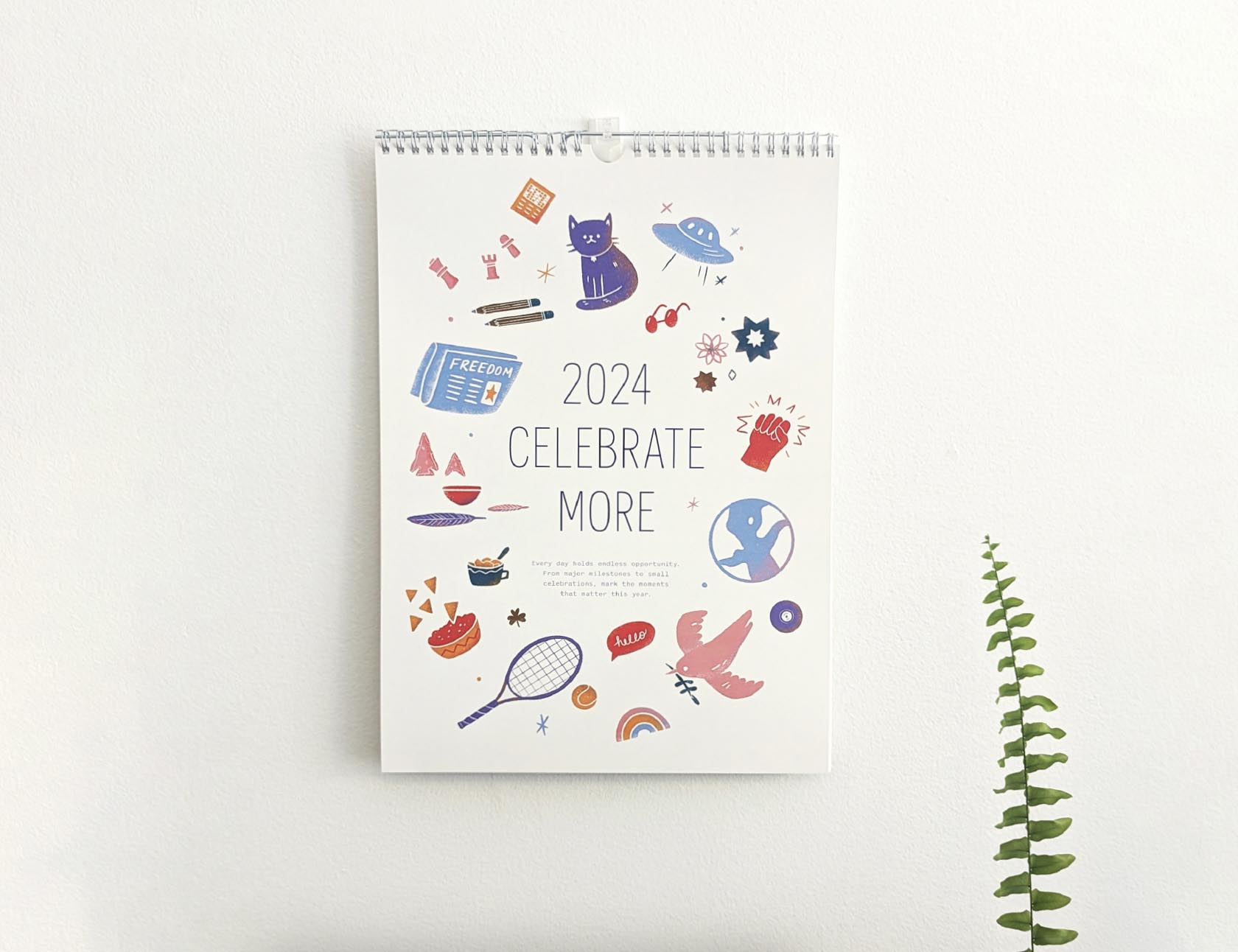 A photo of Redhead's holiday calendar cover which includes colorful illustrations and reads "2024 Celebrate More"